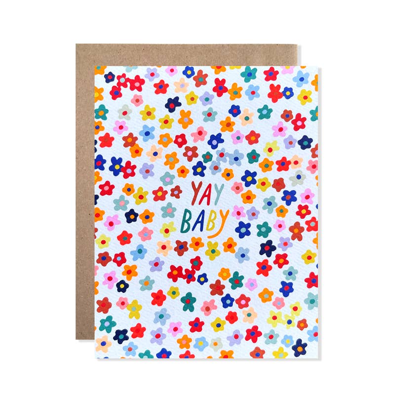 Greeting card with white background and images of multicolored flowers and text says, "Yay baby". Kraft envelope included.