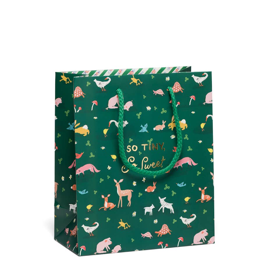 Dark green background with images of tiny animals including pigs, deer, lamb, and geese with gold foil text says, "So time so sweet". Green rope handle. 