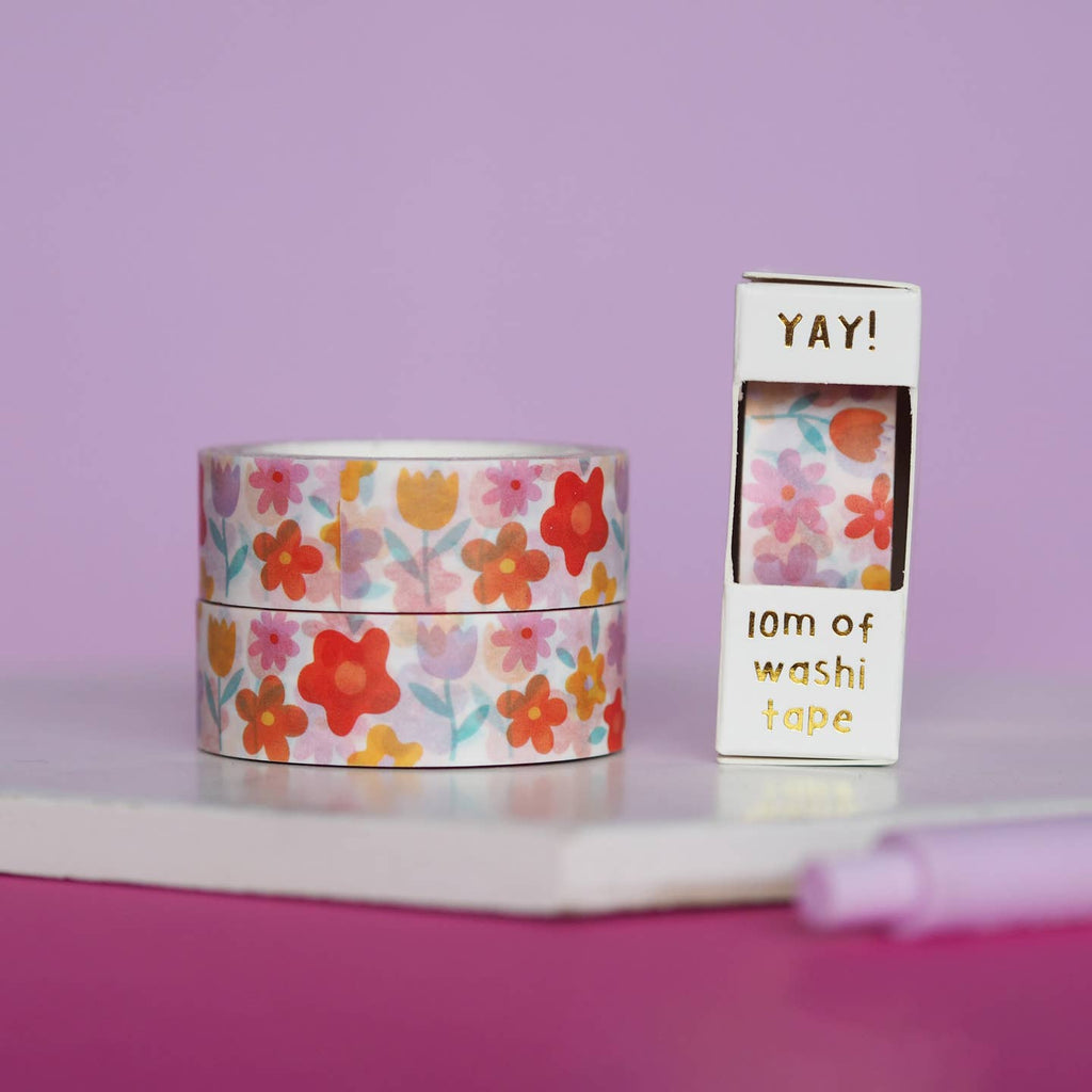 Image of washi tape with cream background with images of red, orange and yellow flowers with pale green stems. 