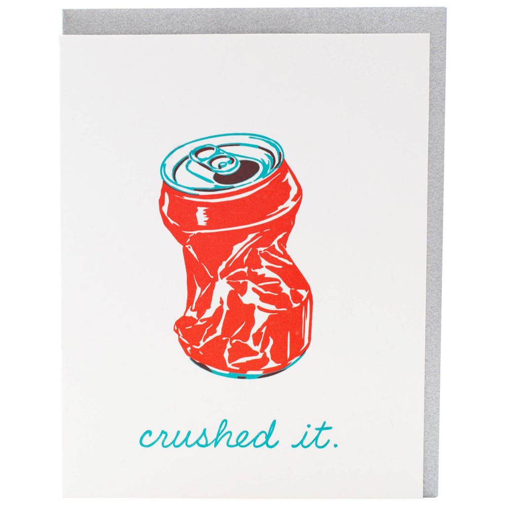 Greeting card with white background and image of crushed soda can in red and aqua. Aqua text says, "Crushed it." Grey envelope included. 