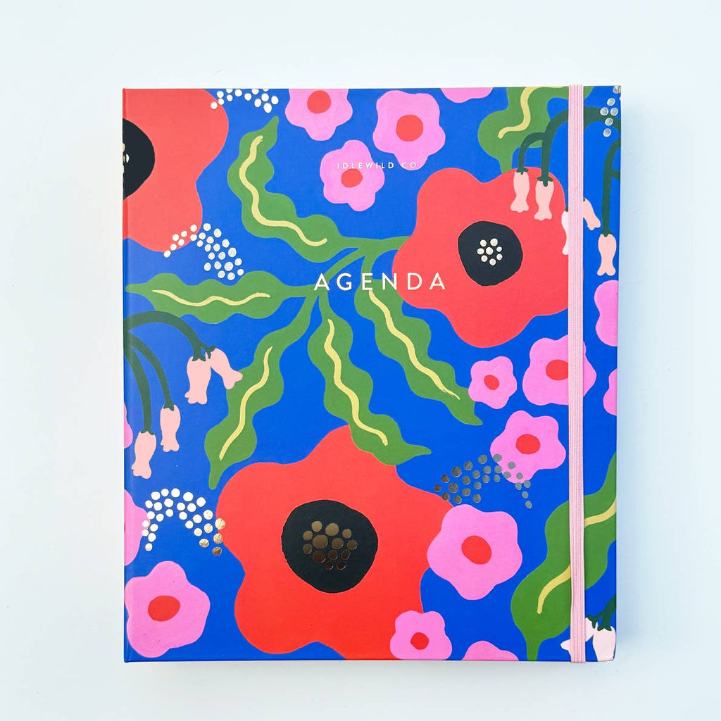Image of cover of planner with blue background with images of red, pink and peach flowers with green and yellow leaves and whit dots. Gold foil text says, "Agenda". 