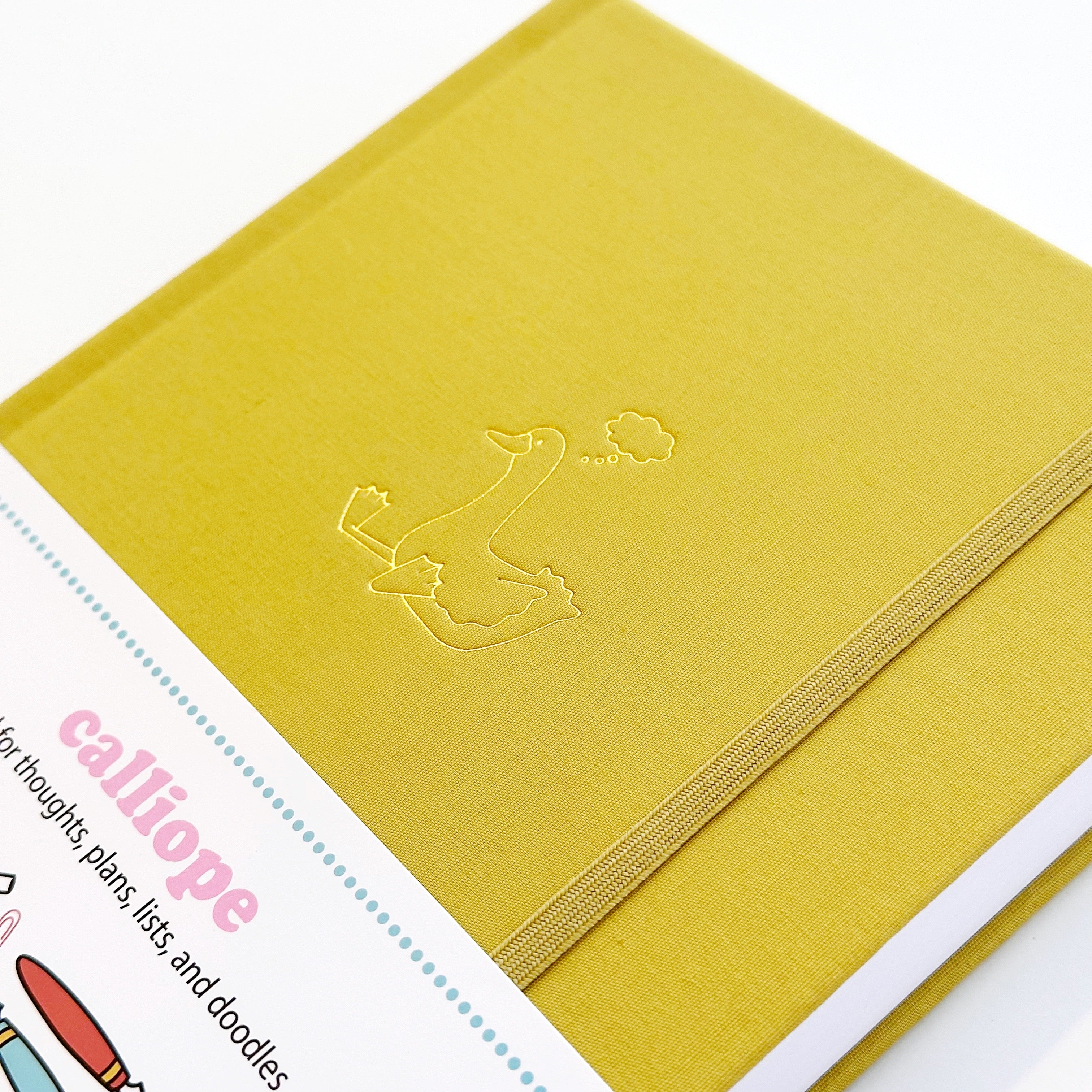 Image of chartreuse journal with gold foil duck with word bubble over his head.