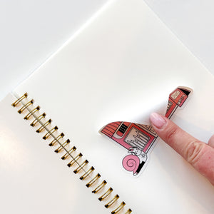 Image of blank page with image of a finger pulling back a sticker off of page. 