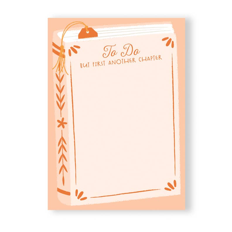 Image of notepad with dark peach background and lighter peach image of a book with brown text t type says, "To Do but first another chapter". 