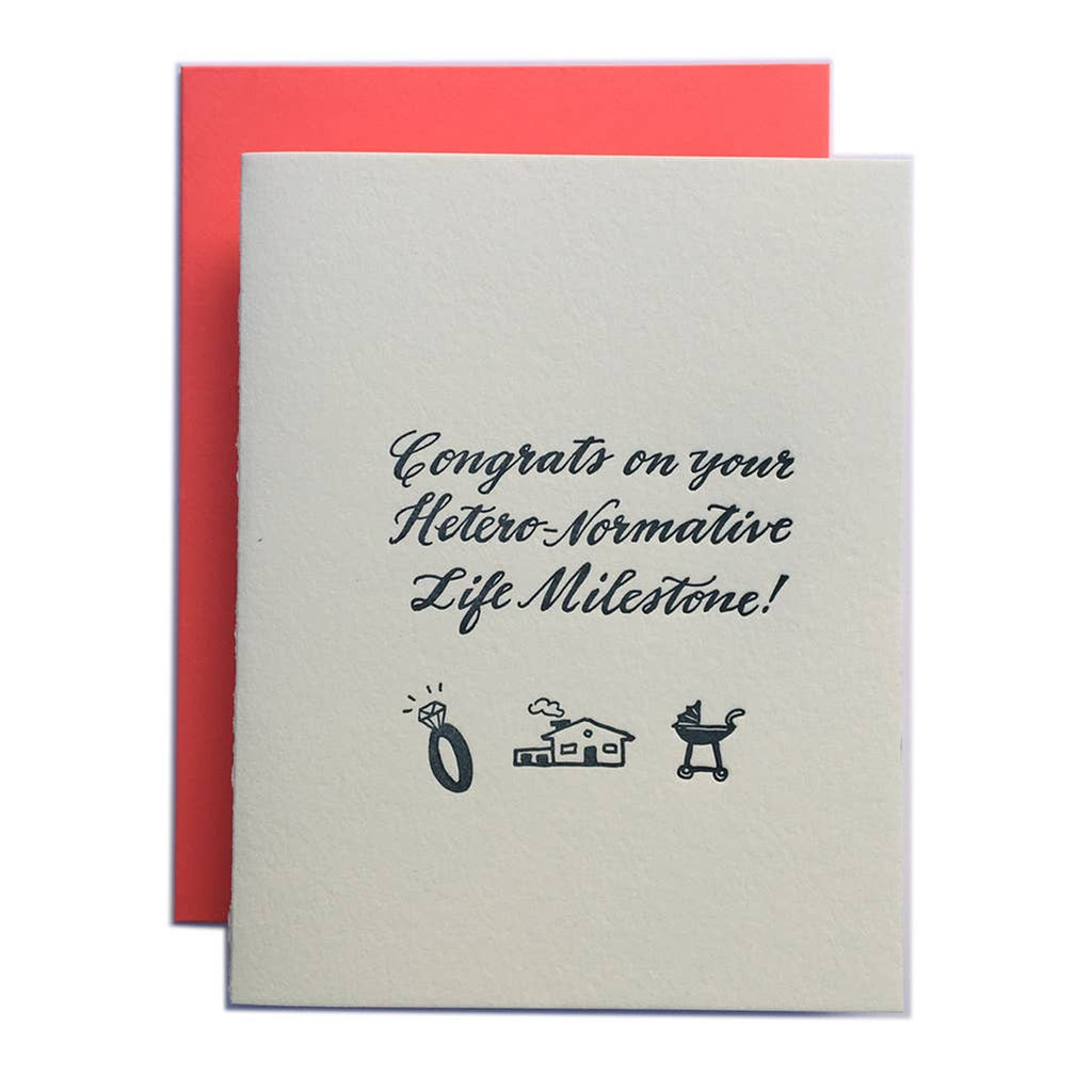 Greeting card with cream background and black text says, "Congrats on your hetero-normative life milesone!" with image of engagement ring, house and baby stroller. Red envelope included. 