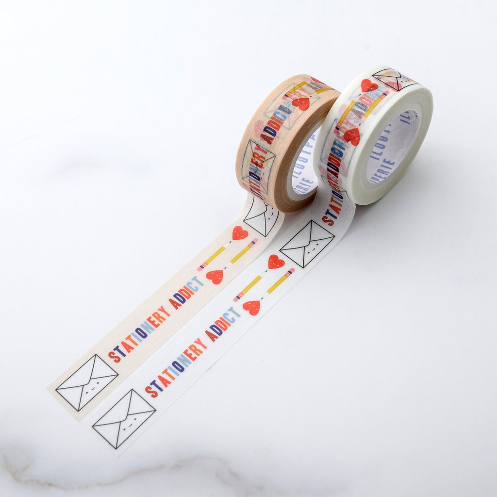 Decorative tape with beige or white background with rainbow text saying, "Stationery Addict". Images of white mailing envelopes, yellow pencils and red hearts.