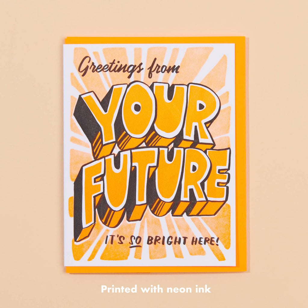 White background with “Your Future” in large neon orange lettering with black lettering saying “Greetings from” and “It’s so bright here”. Neon yellow envelope in included.          