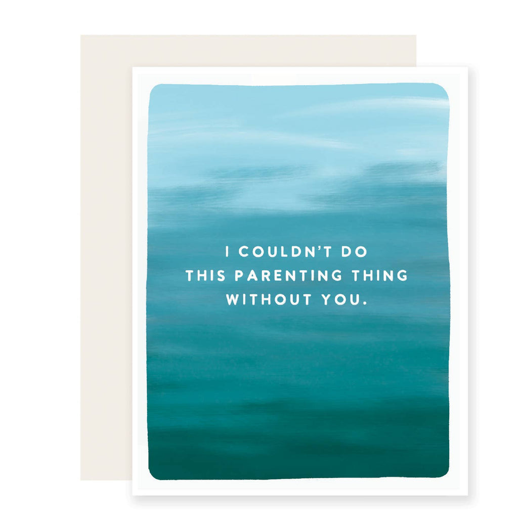White card with image of blue and teal ocean water with white text saying, “I Couldn’t Do This Parenting Thing Without You”. An ivory envelope is included.