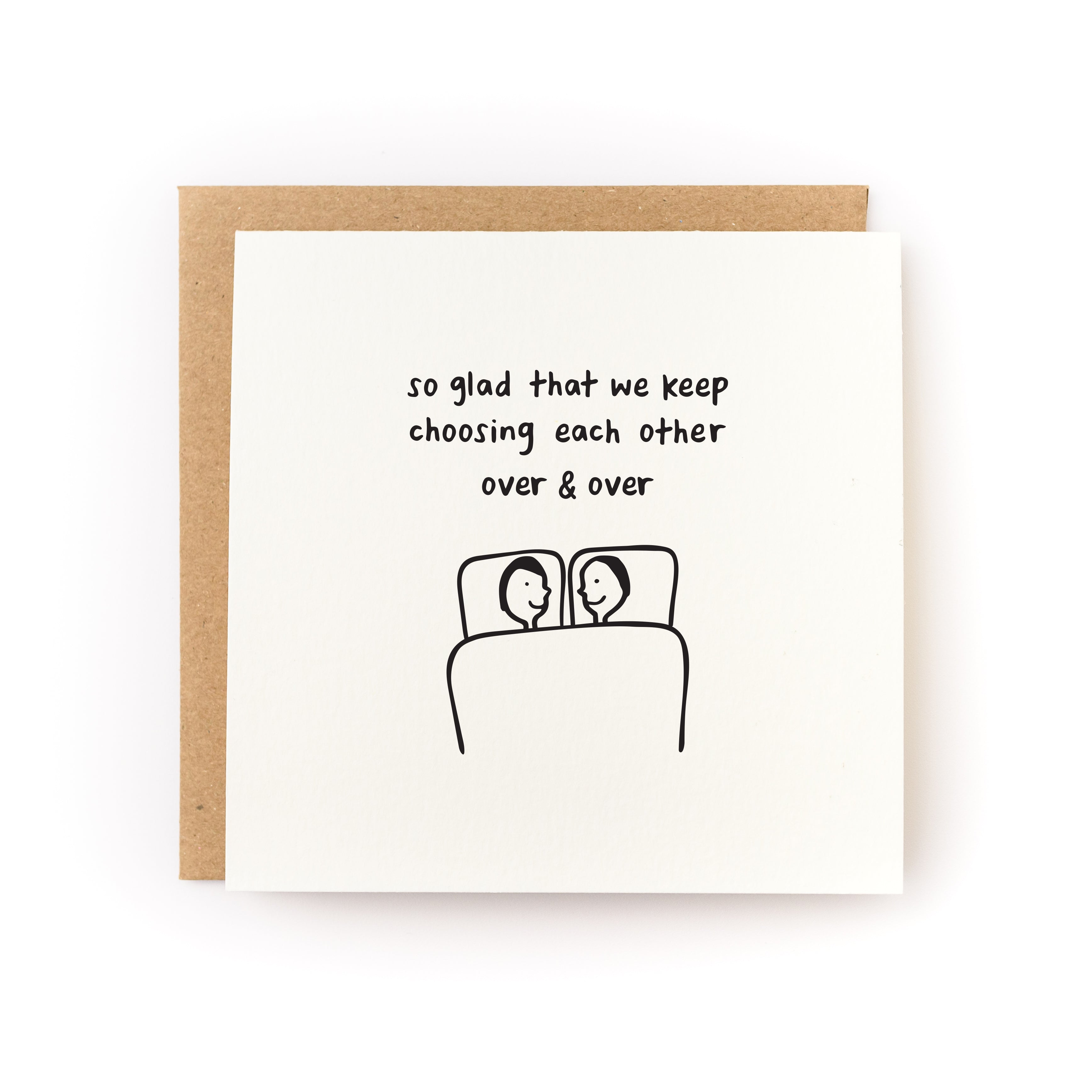 Square white card with black text saying, "So Glad that We Keep Choosing Each Other Over & Over". Images of two people laying in bed together. A brown envelope is included.