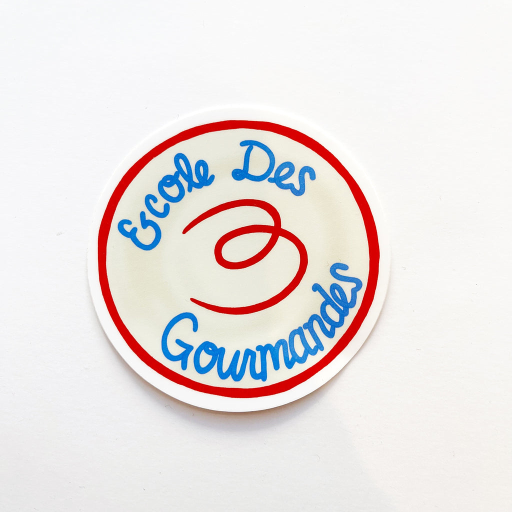 Round sticker with text in french "Ecole Des Trois Gourmandes" in blue with a red border