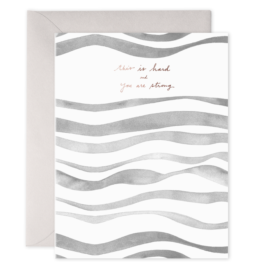 White background with thick wavy lines in shades of gray. Copper foil text says, “This is hard and you are strong”.  A gray envelope is included.  