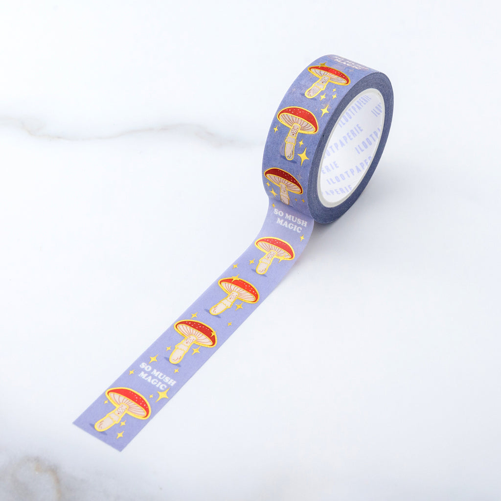 Decorative tape with purple background with white text saying, “So Much Magic”. Images of red mushrooms and yellow stars.