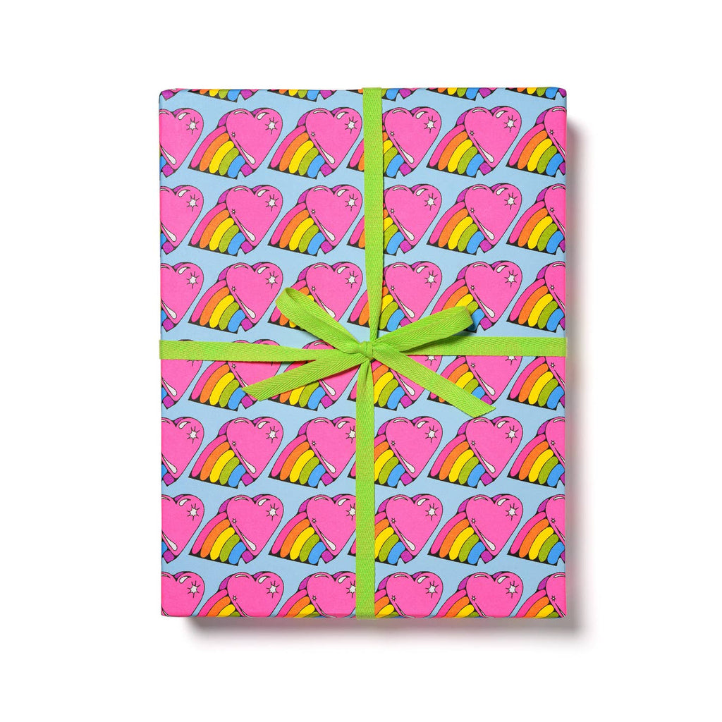 Gift wrap with light blue background and images of bright pink hearts with a rainbow emerging from one side.