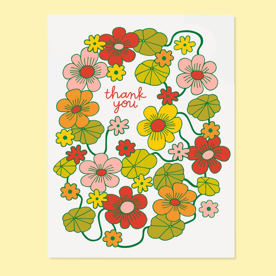 Greeting card with white background and images of flowers in yellow, red, orange and green. Red texts says, "Thank you". Envelope included.