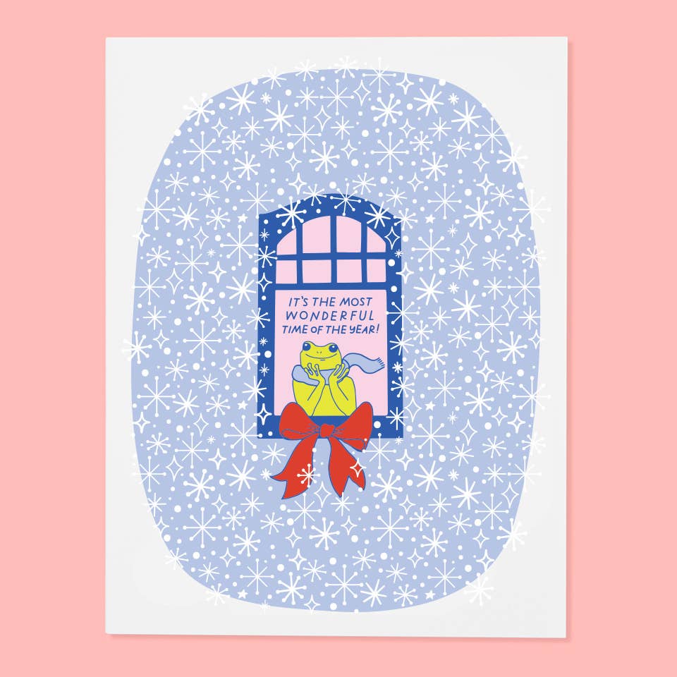 Greeting card with blue and white snowflake background with white border with image of a window with a frog sitting on it. Blue text says, "It's the most wonderful time of the year!" Envelope included. 