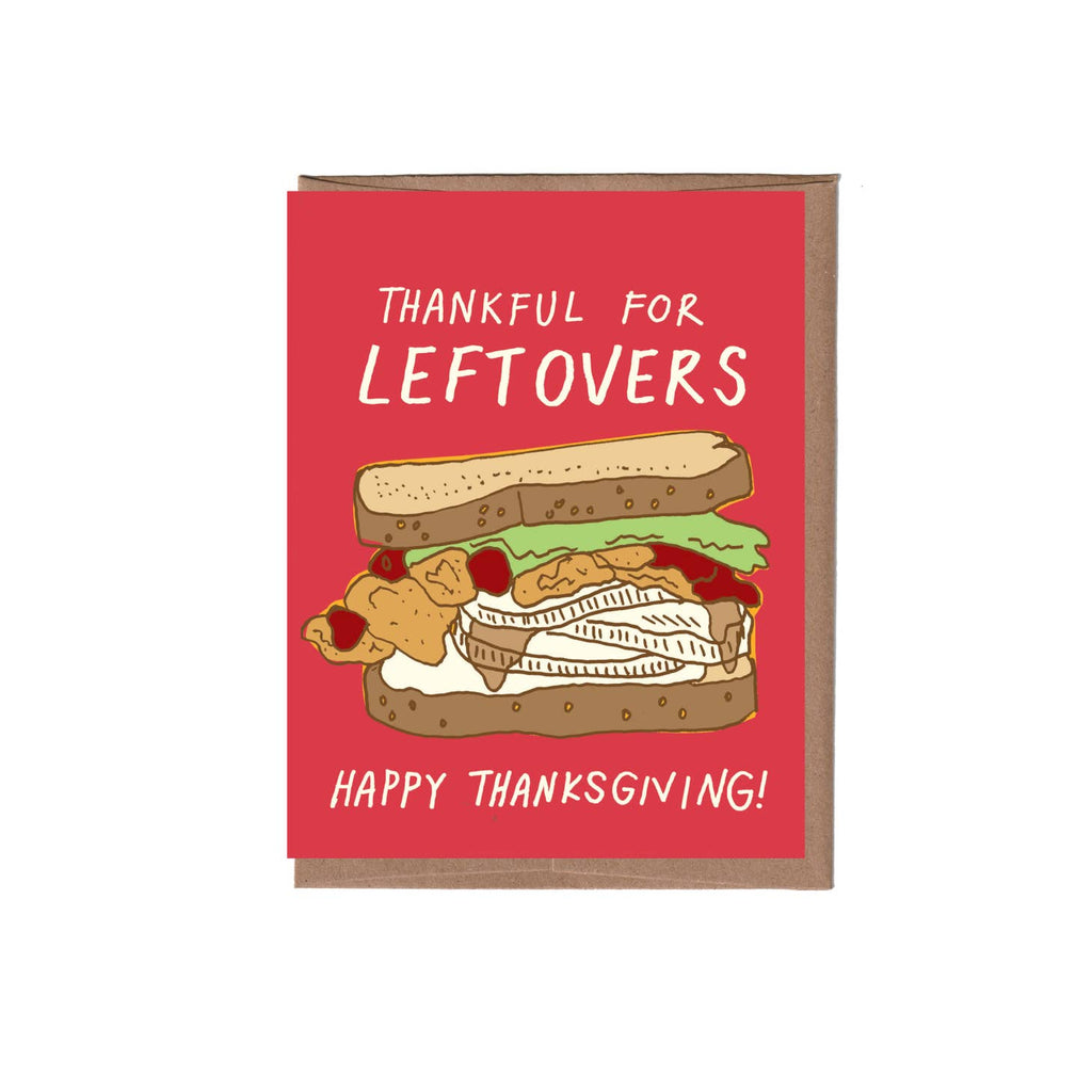 Red background with image of turkey sandwich with tan text says, "Thankful for leftovers Happy Thanksgiving!". Kraft envelope included. 