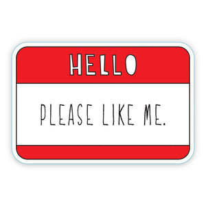 Decorative sticker in the image of Hello sticker in a red and white background with white text says, "Hello" and black text says, "Please like me.". 