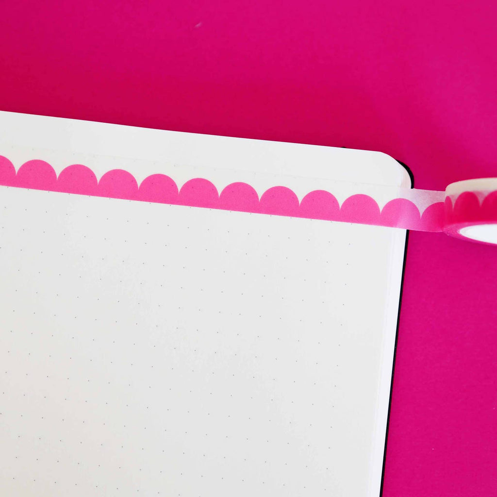 Washi tape with pink scallop design and white edging.