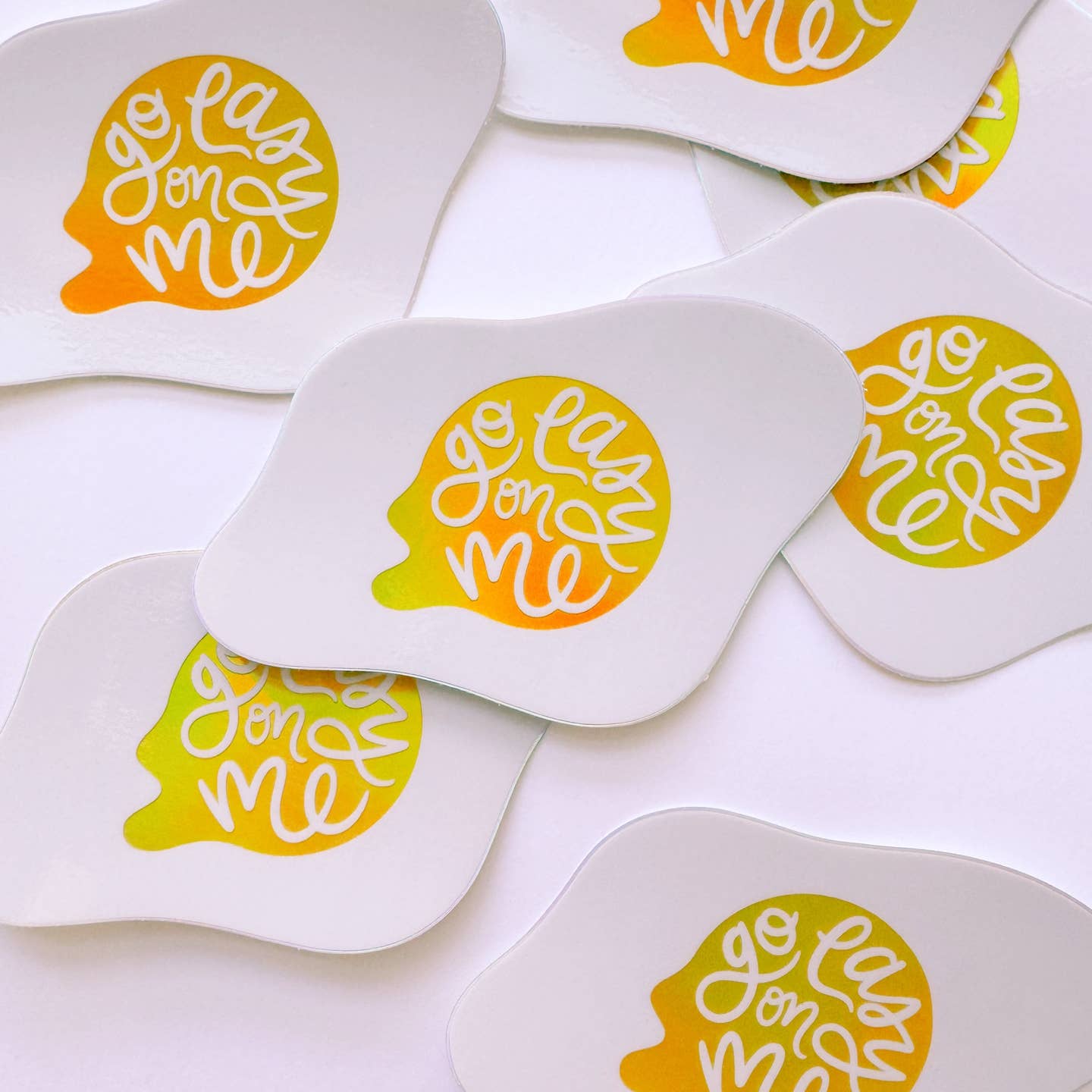 Decorative sticker in the image of an over easy egg with white text on yellow yolk says, "Go easy on me". 