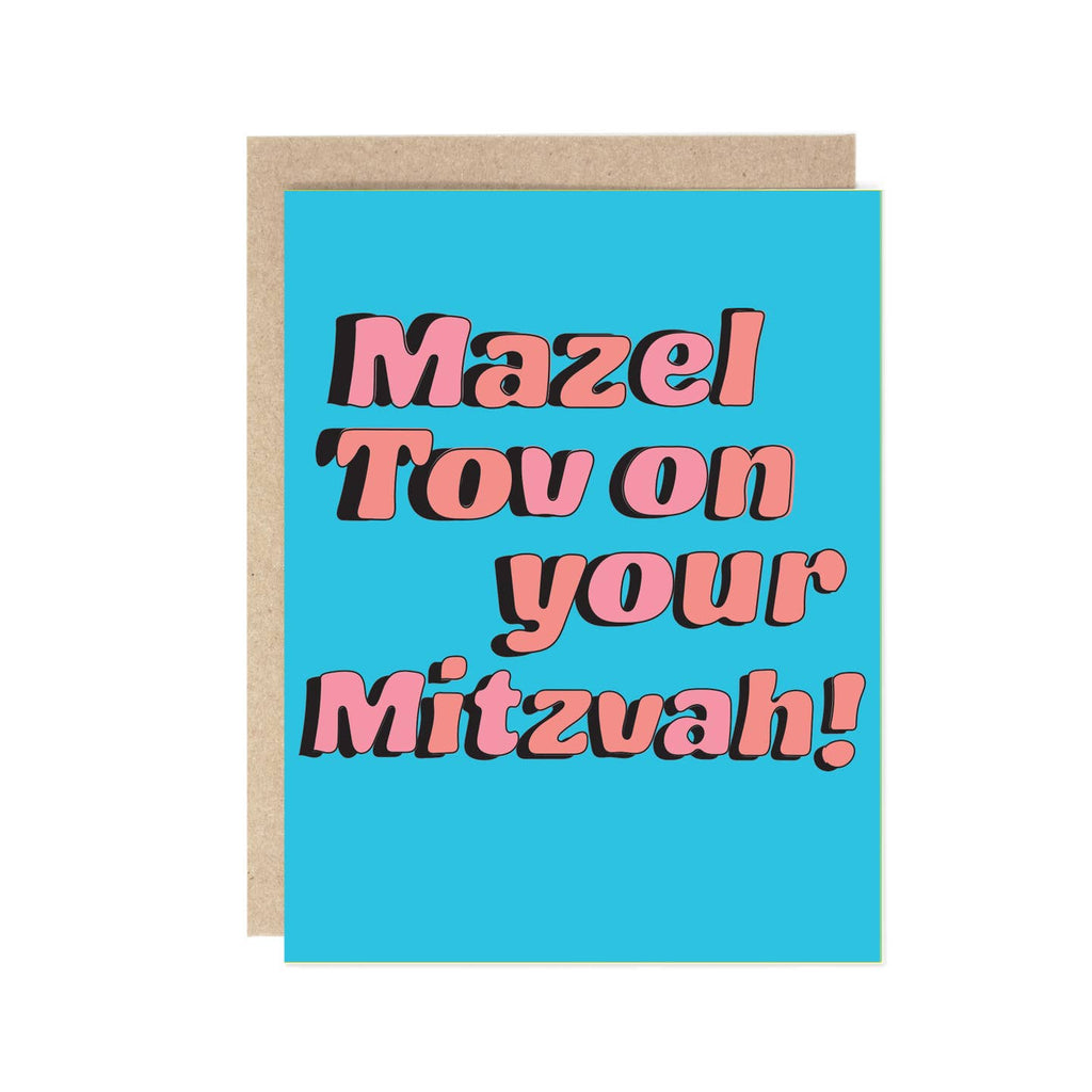 Greeting card with light blue background and pink text says, "Mazel Tov on your Mitzvah!". Kraft envelope included. 