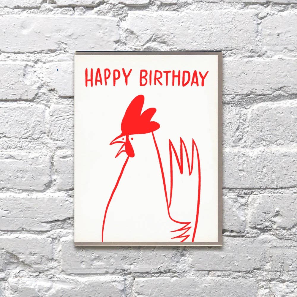 Greeting card with white background and red outline drawing of chicken with red text says, " Happy Birthday". Kraft envelope included.