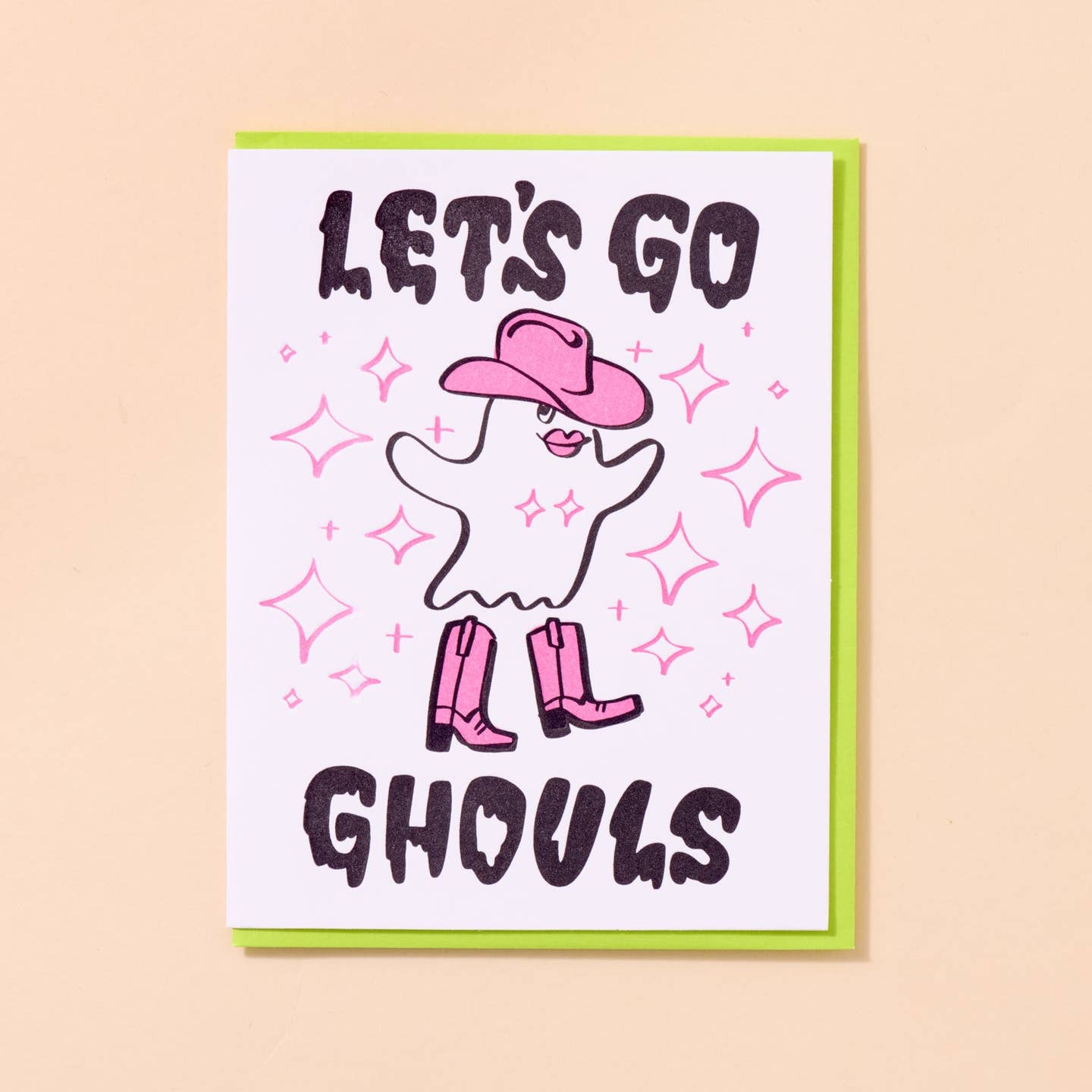 Greeting card with white background with image of a ghost wearing a pink cowboy hat and boots with black text says, "Let's go ghouls". Lime green envelope included. 