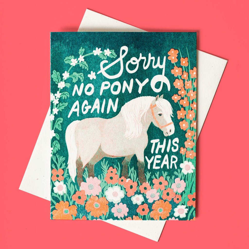 Teal background with orange and peach flowers at bottom with image of white and tan pony. White text says, "Sorry no pony again this year". White envelope included. 