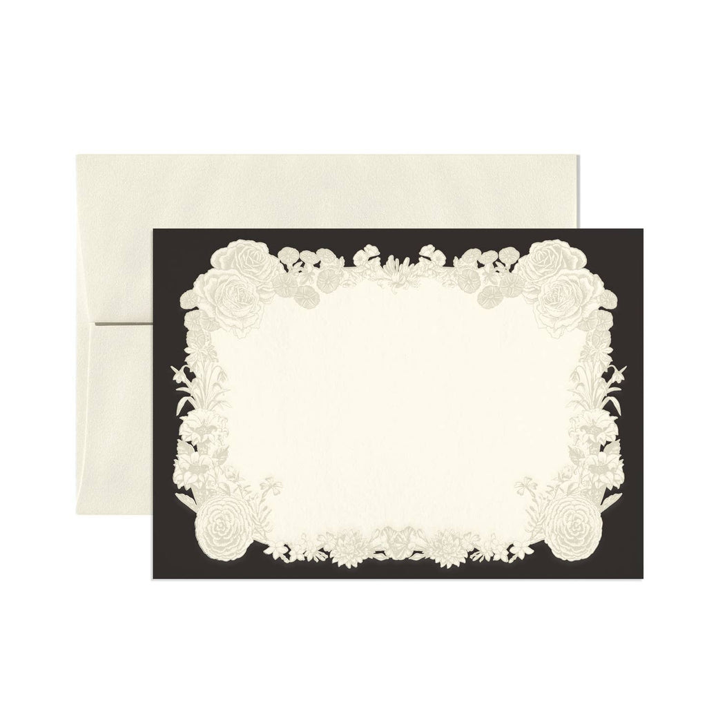 Note card set with black border and white center with images of wreath of white flowers. Cream envelopes included.