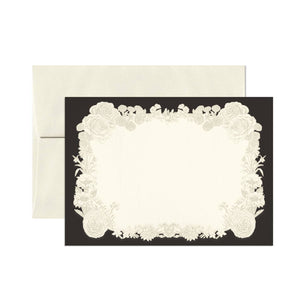 Note card set with black border and white center with images of wreath of white flowers. Cream envelopes included.