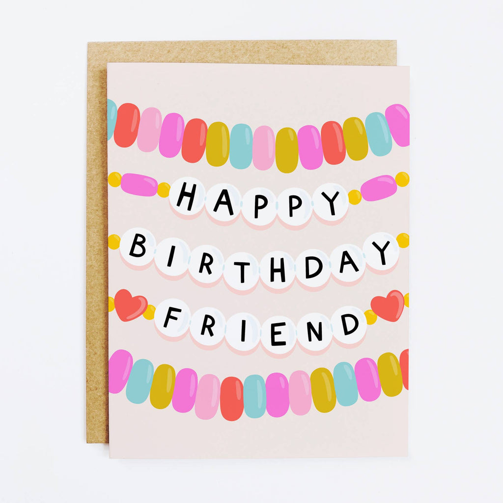 White background with image of friendship bracelets in pink, red, green, aqua and black and white beads with text says, "Happy Birthday Friend". Kraft envelope included. 