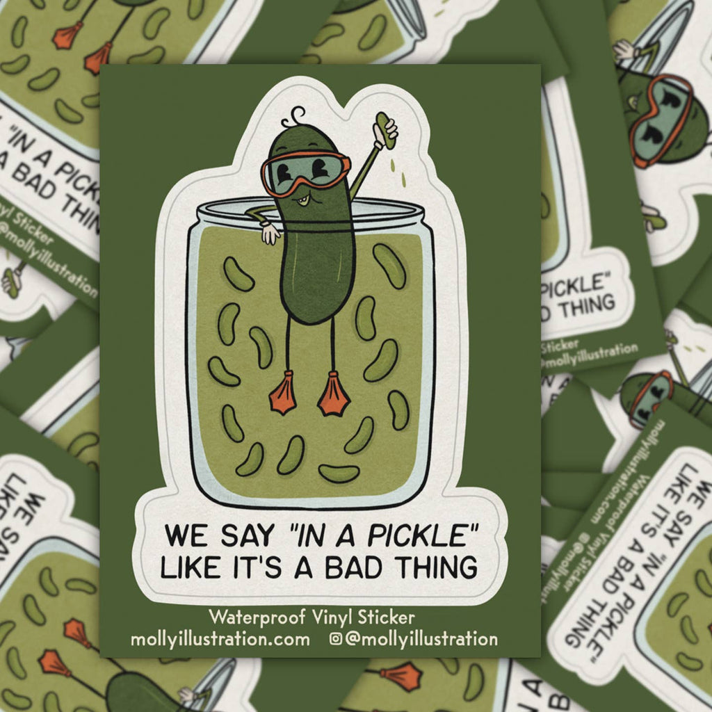 Decorative sticker with white background and image of a pickle hanging onto the edge of a jar of pickles and black text says, "We say in a pickle like it's a bad thing".