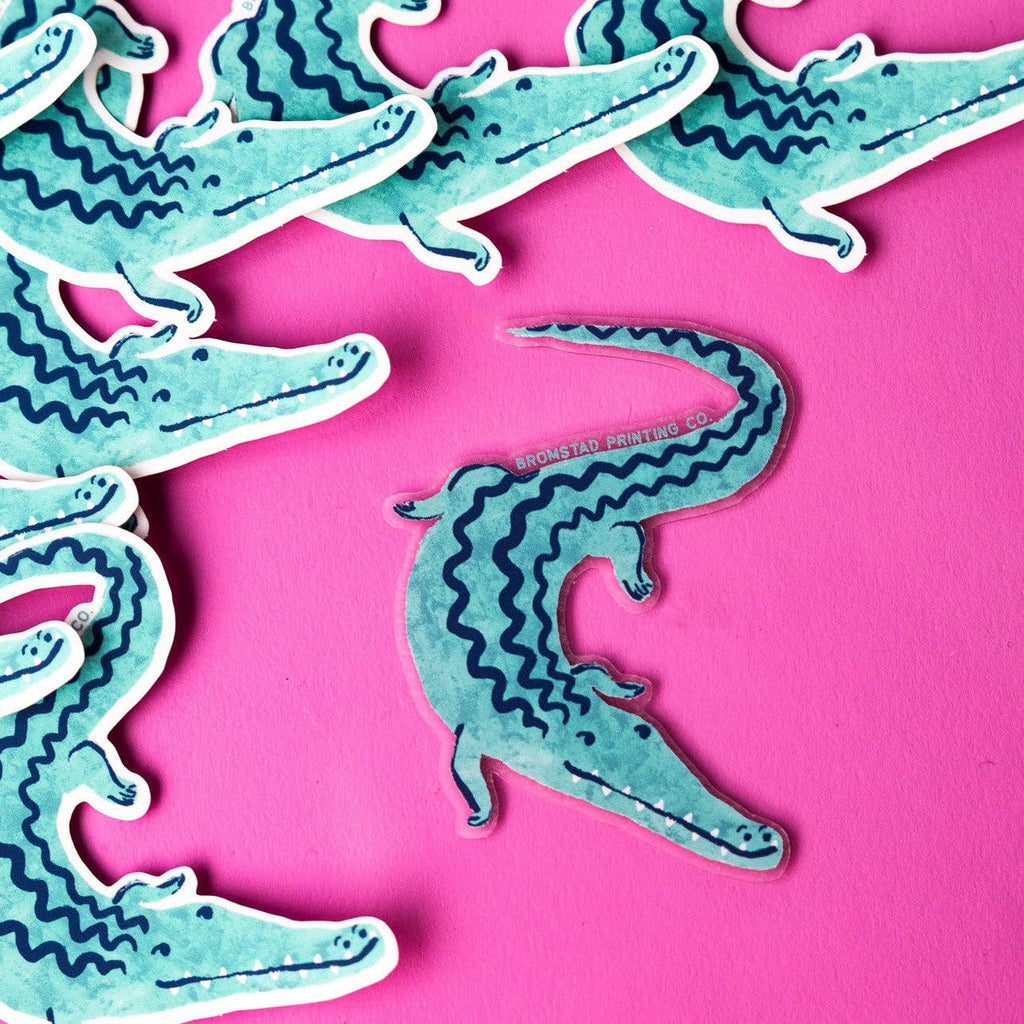 Decorative sticker in the image of a crocodile in aqua with navy blue detailing. 