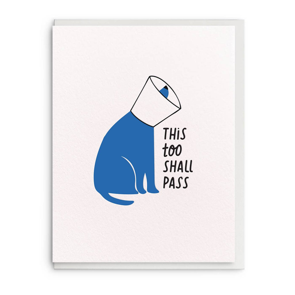 Greeting card with white background and image of a blue dog wearing a cone and black text says, "This too shall pass". Envelope included.