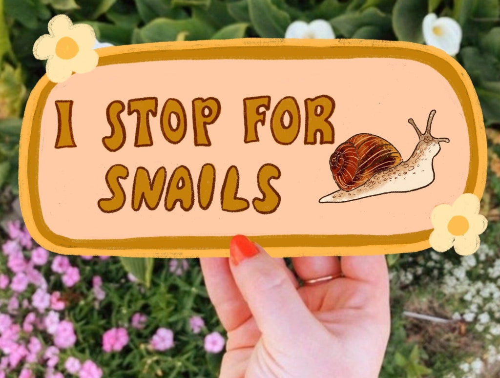 Decorative sticker with tan background with brown and gold border  and image of snail with brown text says, "I stop for snails". 