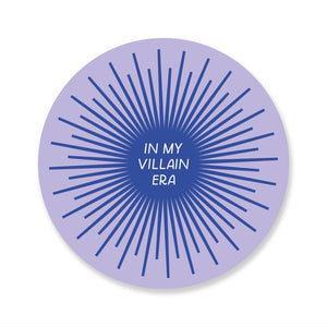 Decorative sticker with lilac background with blue center and blue rays coming from circle. White text says, "In my villain era". 