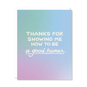 Greeting card with aqua, blue and lavender background and white text says, "Thanks for showing me how to be a good human.". White envelope included. 