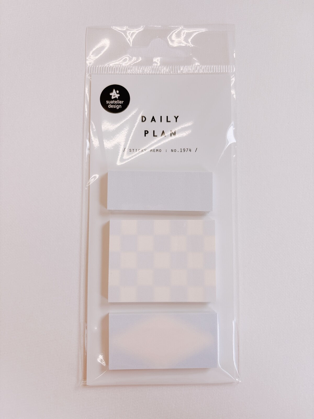 Image of package of three pads of sticky notes.