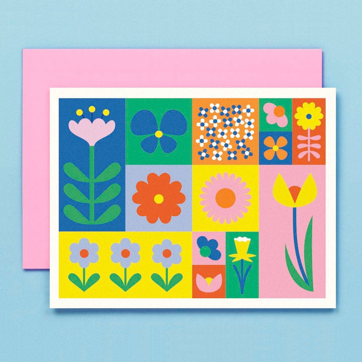 Image of card with colorblocks in blue, yellow, pink, orange and green stems. Pink envelopes included. 