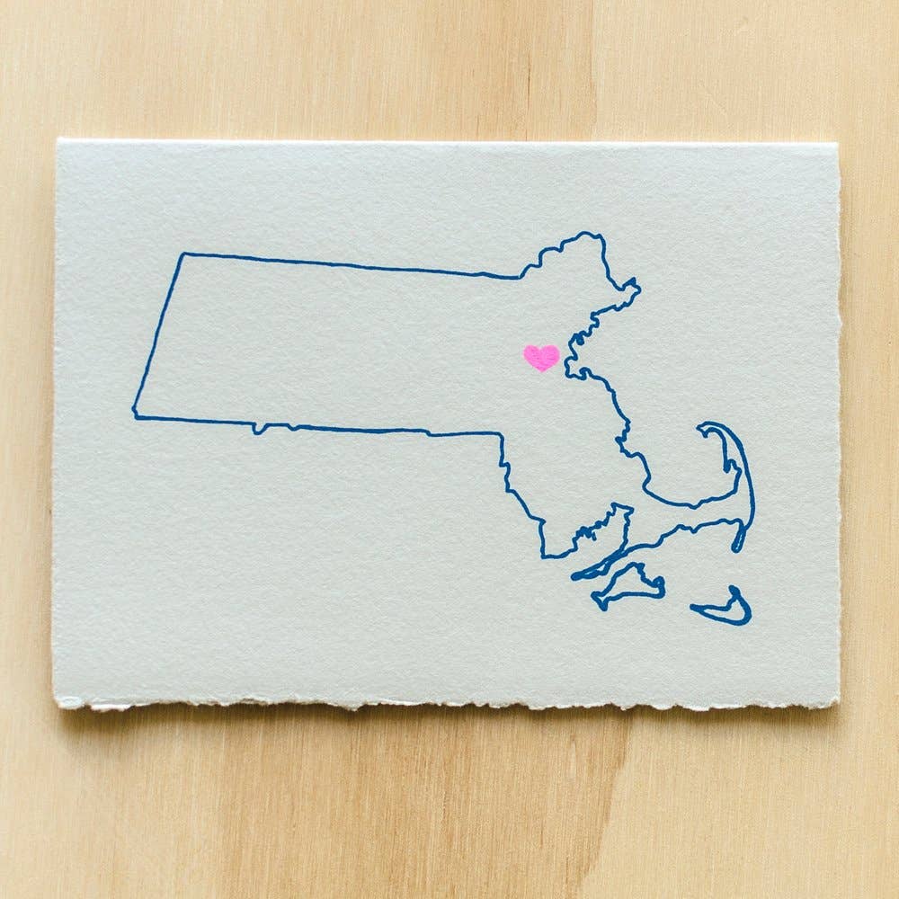 Greeting card image with ivory background with image of outline of Massachusetts with a pink heart were Boston. Envelope included. 