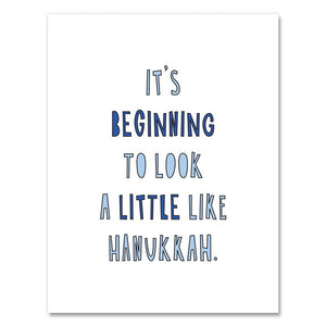 Greeting card with white background and blue text says, "It's beginning to look a little like Hanukkah". Envelope included. 