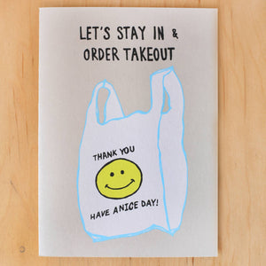 Greeting card image with white background and image of a take-out bag with a yellow smiley face and black text says, "Thank you Have a Nice Day!" and "Let's stay in & order takeout". Envelope included. 