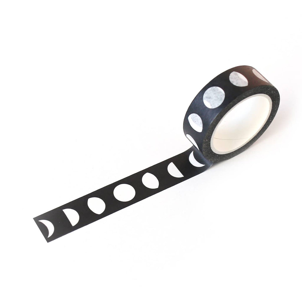 Image of roll of washi tape with black background with white images of moon phases.