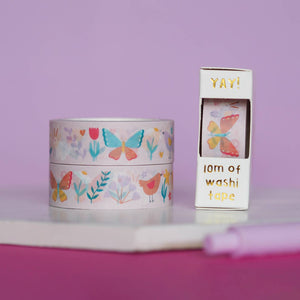 Image of washi tape with pale pink background and images of butterflies, flowers and birds in aqua, peach, pink, pale green and white. 