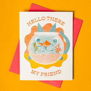 Ivory background with image of fishbowl with teal cat looking into the bowl with a goldfish  and orange text says, "Hello there my friend". Red envelope is included.