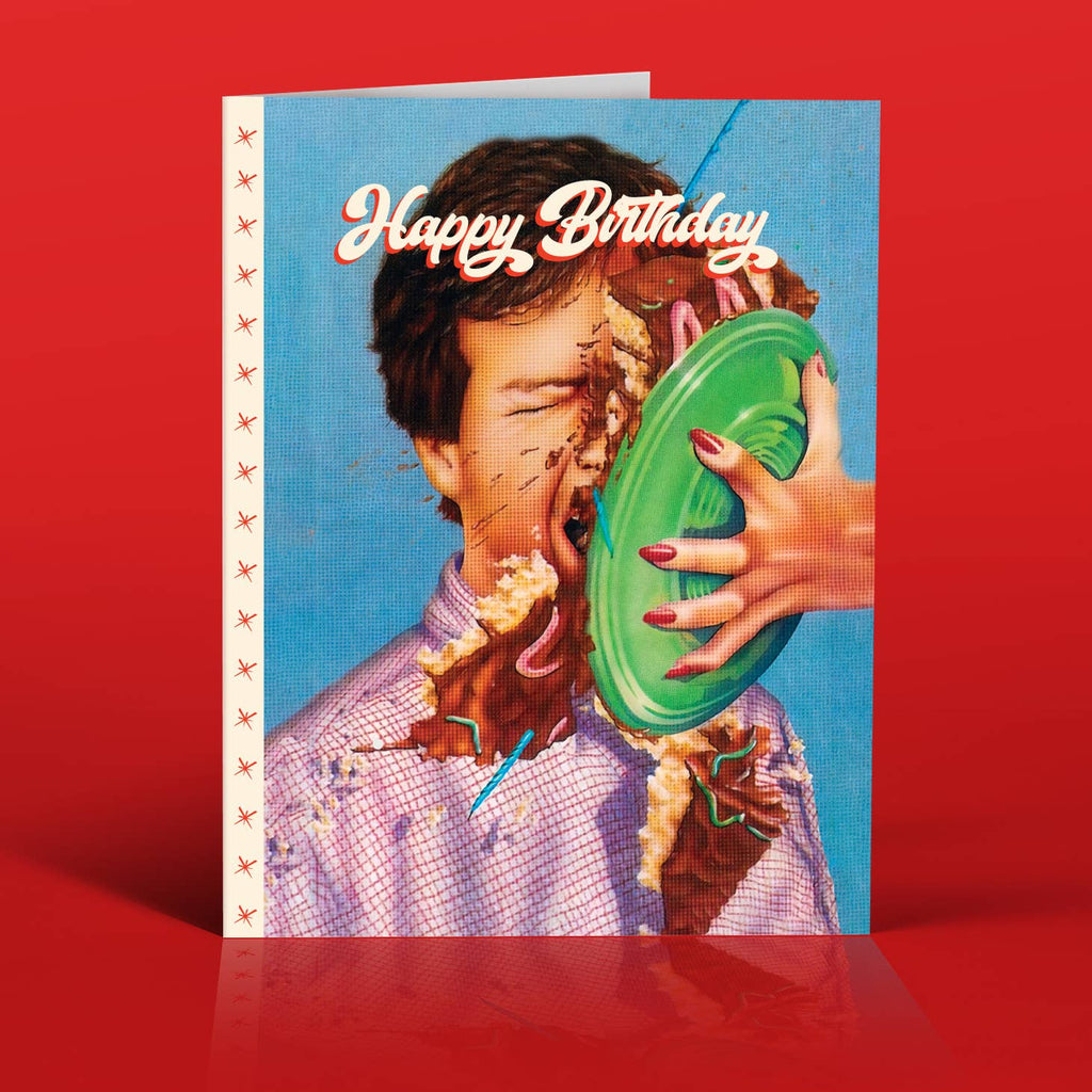 Blue background with image of a man's face with a cake being smashed into the face. White text says, "Happy. birthday". Envelope is included.