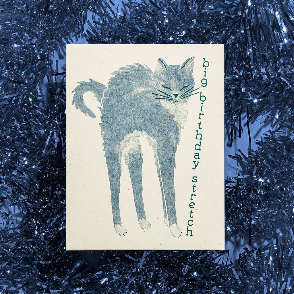 Greeting card with cream background and image of a blue cat with arched back and blue text says, "Big birthday stretch". Envelope included.