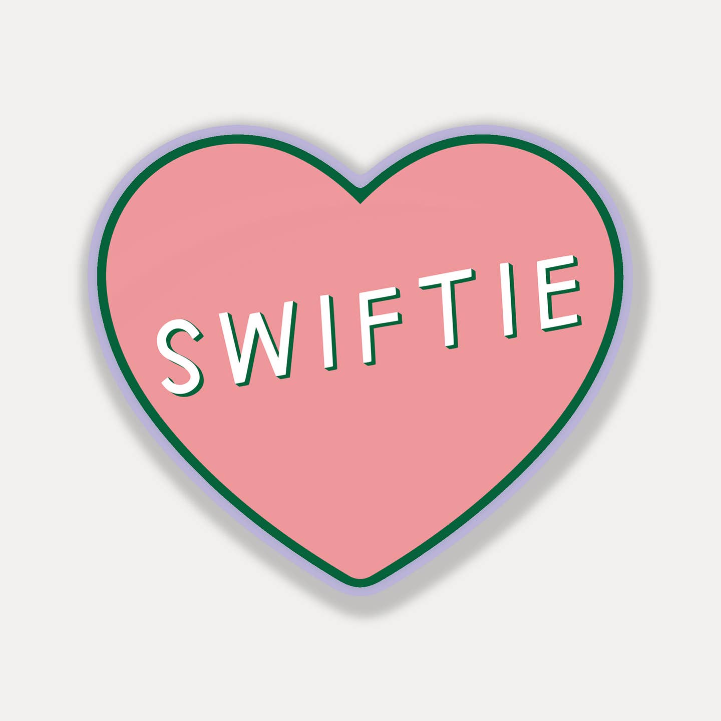 Decorative sticker  in heart shape with pink background and white text says, "Swiftie". 