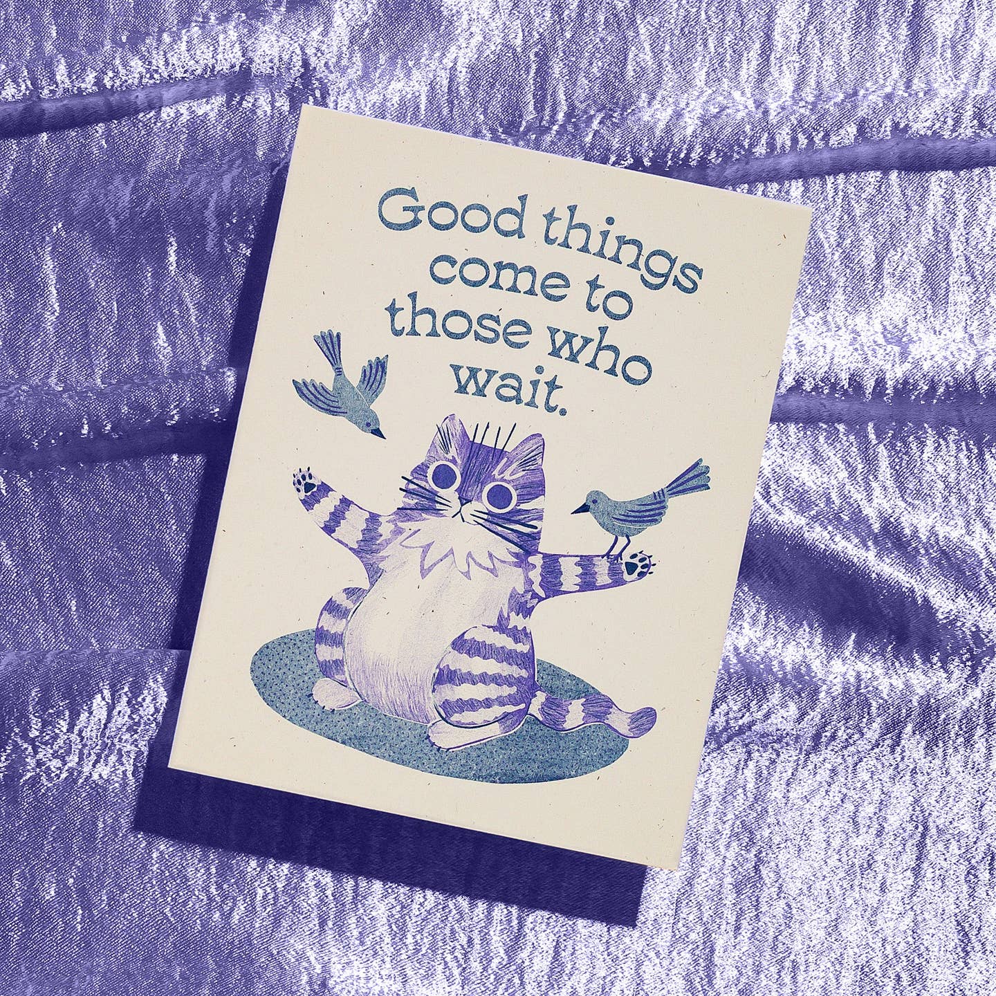 Greeting card with cream background and blue image of a striped cat with its arms stretched out and two bird landing on its arms. Blue text says, "Good things come to those who wait.". Envelope inclosed.