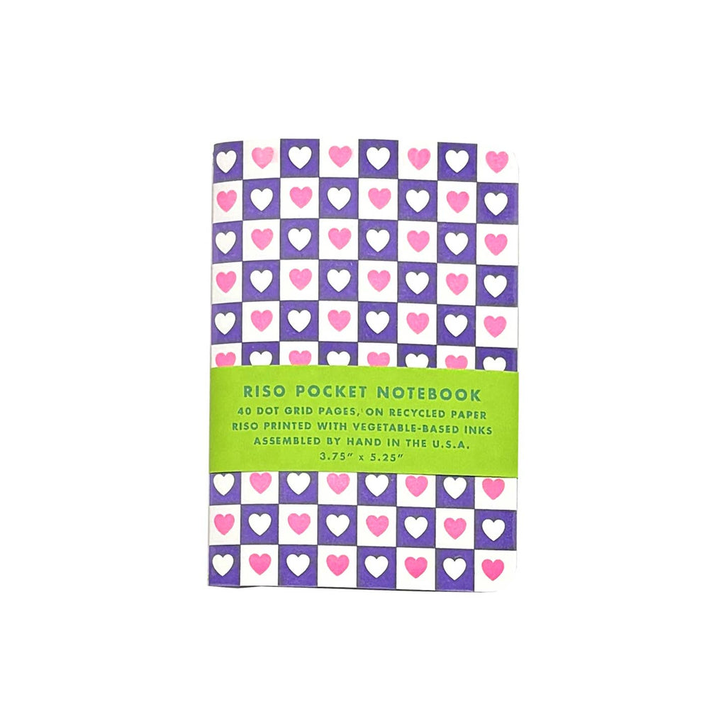 Notebook with purple and white checkered background with pink hearts in white checks and white hearts in purple checks. 