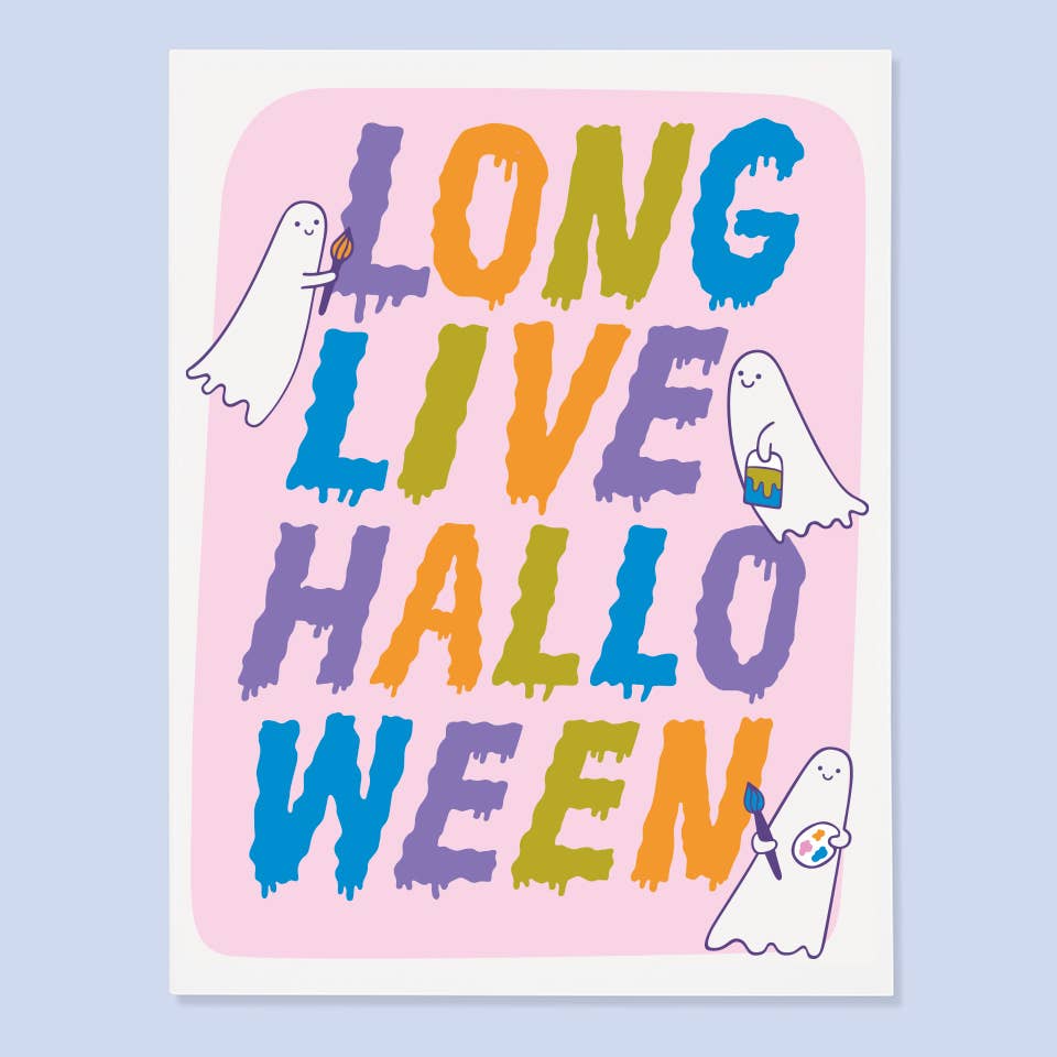 Greeting card with pink background and white border with images of ghosts painting a sign in purple, orange, green and blue text says, "Long live Halloween". Envelope included. 